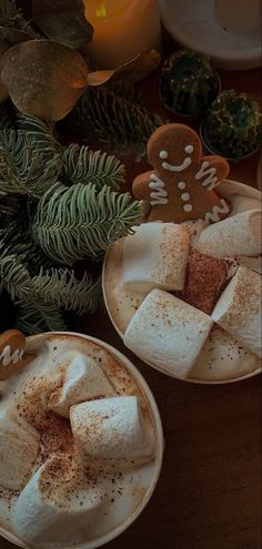 two white plates topped with marshmallows and ginger cookies