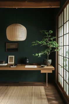 a room with green walls and wooden flooring has a large plant on the table