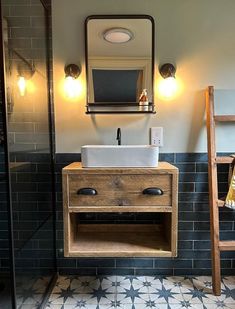 a bathroom with a sink, mirror and wooden ladder in it's center area