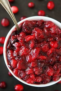 a bowl filled with cranberry sauce on top of a table