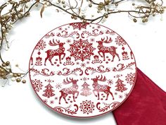 a red and white plate with reindeers on it