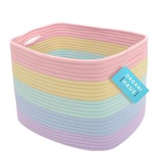 a pink, yellow and blue striped basket with a tag on it