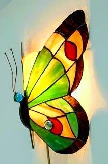 a stained glass butterfly light hanging on the wall