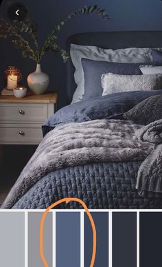 an image of a bedroom with blue and grey colors in the bedding, pillows and blankets