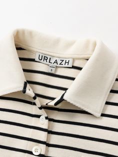 Details: Timeless striped element polo shirt with textured beige color tone Classic lapel collar, chest rubber label design Black and white stripes with solid color blocking Loose oversize fit Materials & Care: Cotton 100% Hand wash | Dry clean Do not bleach Size & Fit: Model is 5'7", Bust 32, Waist 24, Hips 35, wearing a size S Item #: IM3SY06 Rubber Label, Design Black And White, Polo Men, Polo T Shirt, Black And White Stripes, Striped Polo Shirt, Color Tone, Lapel Collar, Label Design