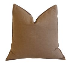 a brown pillow on a white background