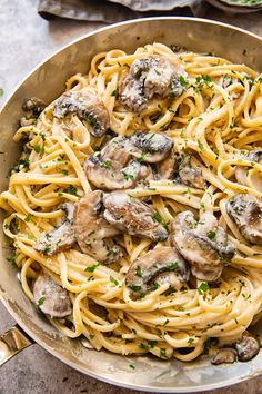 mushroom pasta in a pan with parsley on top and text overlay that reads mushrooms pasta find the recipe at via alika com