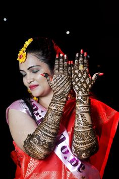 a woman with her hands covered in henna