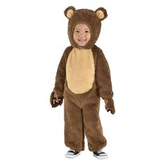 a toddler in a bear costume standing with his hands on his hips and smiling