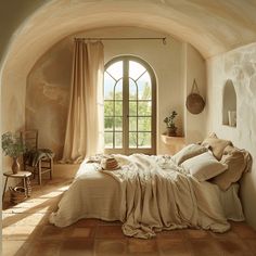 a bed sitting under a window in a bedroom