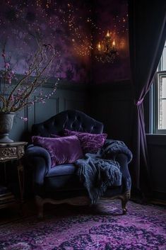 a purple couch sitting in front of a window next to a table with a vase on it