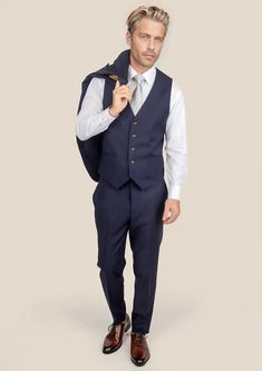 Elevate your style with our custom-made Stratos Blue Sharkskin Vest. With its exquisite craftsmanship and luxurious Super 110s wool mohair blend, this vest is the perfect finishing touch for any suave look. Experience the ultimate sophistication with this must-have piece in your wardrobe. Tailored Wool Vest For Semi-formal Occasions, Elegant Blazer With Vest For Business Casual, Elegant Business Casual Blazer With Vest, Business Vest With Hidden Button Closure, Tailored Vest With Hidden Button Closure And Notch Lapel, Winter Classic Sleeveless Blazer, Elegant Business Casual Suits With Vest, Formal Winter Sleeveless Vest, Sleeveless Business Vest With Hidden Button Closure