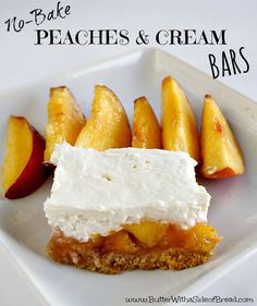 a white plate topped with slices of peaches and cream covered desserts on top of each other