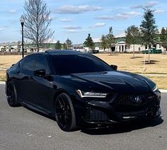 a black sports car is parked on the street