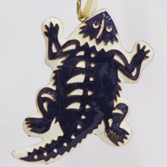 a blue and white lizard ornament hanging from a chain