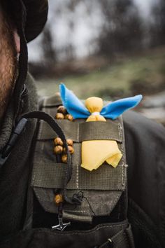 a man wearing a back pack with an origami bird on it