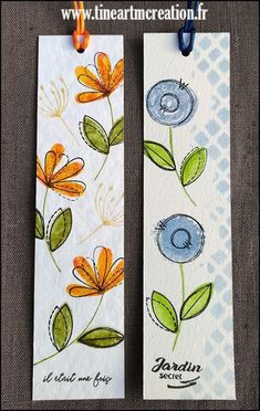 two bookmarks with flowers painted on them