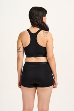 Iona Is Our Crop Top Shape Made In Super Soft Certified Bamboo Fabric. Available Here In Our Iconic Black! Our Fit Crop Top With Racer Back Light Support Stretch Elasticated Underband The Fabric 68% Bamboo, 28% Organic Cotton, 4% Elastane Made From Fsc Certified Bamboo, Ocs Organic Cotton And Elastane. The Fabric Is Super Soft, Breathable And Stretchy Yak Care Machine Washable On A Very Gentle Wash Reshape While Damp. Modelled By Emily, Uk 10, 5Ft 6, Wears S Made In Turkey 68% Bamboo, 28% Organi Black Stretch Cotton Sports Bra, Bra Friendly Black Cotton Crop Top, Black Racerback Top With Medium Bust Support, Black Cotton Bra Friendly Crop Top, Black Cotton Bra-friendly Crop Top, Black Cotton Crop Top Bra Friendly, Black Medium Support Top For Loungewear, Black Sports Bra With Medium Bust Support For Loungewear, Lucy Yak