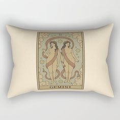 a rectangular pillow with an image of two women in the center and words gemini on it