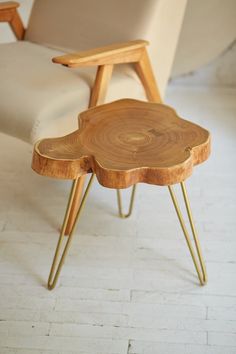 two wooden tables sitting on top of each other in front of a white couch and chair