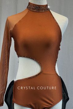 a mannequin wearing a brown top and black pants with crystal beads on it