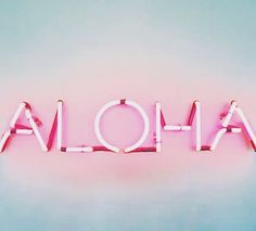 the word aloha spelled in neon pink letters on a light blue background,