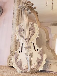 a white violin sitting on top of a table