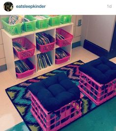 two pink and green crates sitting on top of a rug