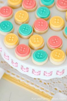 decorated cookies with colorful buttons on a cake plate