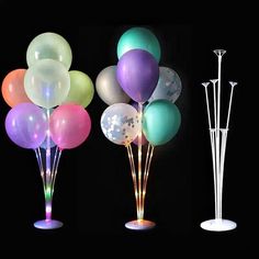 three different colored balloons are in the shape of sticks and vases with lights on them