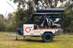 an off - road vehicle with two bikes on the back