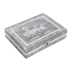 an ornate silver box with horses on it