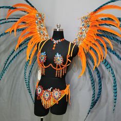 a mannequin with orange and blue feathers on it