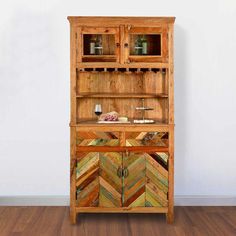 a wooden cabinet with glass doors and drawers