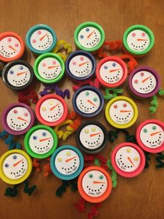 many different colored clocks sitting on top of a wooden table