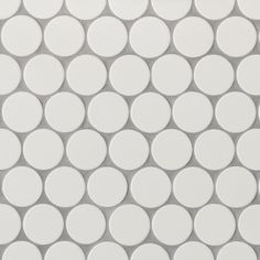 white circles are arranged on the surface of a tile pattern that looks like it is made out of ceramic tiles