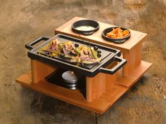 a wooden table topped with plates and food