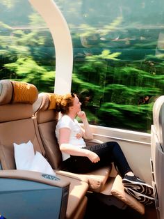 a woman sitting in the seat of an airplane