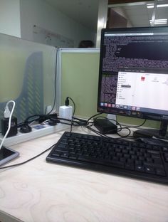 a computer monitor sitting on top of a desk next to a keyboard and mouse,