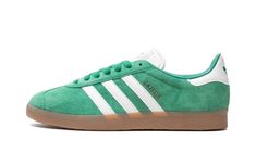 The adidas Gazelle “Court Green/Gum” is a green-based colorway of the popular style.  The adidas Gazelle “Court Green/Gum” features a Court Green suede upper with contrasting white leather Three Stripes branding on the sides.  Gold “Gazelle” detailing is stamped on the lateral side of the mid-panel.  More white leather can be found on the heel tab.  Classic adidas detailing appears on the heel and tongue.  Underfoot, a gum rubber sole completes the look.  Release date: January 1, 2024 Green Sporty Skate Shoes With Gum Sole, Adidas Green Sneakers With Translucent Outsole, Adidas Green Skate Shoes, Green Adidas Sneakers With Logo, Green Casual Custom Sneakers With Gum Sole, Casual Green Custom Sneakers With Gum Sole, Adidas Green Skate Shoes With Boost Midsole, Adidas Green Skate Shoes With Logo, Green Adidas Skate Shoes With Logo