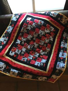 a red and black quilt sitting on top of a chair