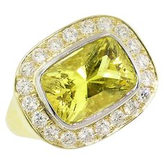 A rare canary tourmaline radiates with a luscious, lemony yellow color. Precision cut for exquisite symmetry and brilliance, this gemstone is pure, sunny joy. The bold "Aphrodite" ring pairs knockout scale with voluptuous lines. Exquisite diamonds frame the canary tourmaline in an elegant and modern halo. -4.57ct Canary Tourmaline (GIA Report #2195710282) -0.60ct Diamonds -18kt Gold and Platinum -ring size 7.75 -product number: TM-20.3 -made in the USA by Cynthia Scott Jewelry ABOUT THE GEMSTONE Aphrodite Ring, Chrome Tourmaline, Gold Bubbles, Bubble Ring, Spessartite Garnet, Rubellite Tourmaline, Gold Cocktail Ring, Tourmaline Jewelry, Gold Cocktail