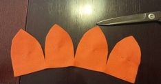 an orange piece of paper cut out with scissors