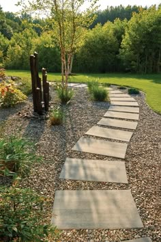 a stone path in the middle of a garden