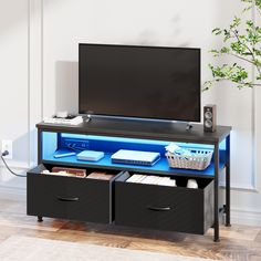 an entertainment center with two drawers and a flat screen tv mounted on it's side