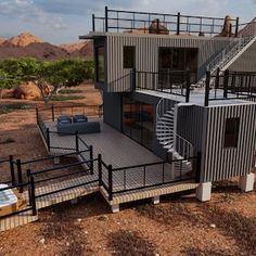 a house made out of shipping containers in the desert