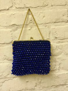 This amazing 60's beaded purse, is sophisticated and so elegant. Made with gold pleated hardware, kisslock closure. There is no material tag but the inside lining feels like silk. Perfect for special ocassions. Dark purple. In excellent condition. Handsewn. Evening Handheld Beaded Clutch, Handmade Blue Bag For Events, Blue Handmade Bag For Events, Vintage Handmade Evening Bag For Party, Vintage Handmade Evening Bag For Events, Blue Beaded Evening Bag For Formal Occasions, Vintage Handmade Coin Purse For Party, Vintage Pouch Coin Purse For Party, Handmade Blue Evening Bag For Formal Occasions