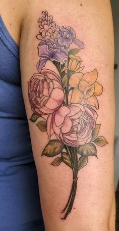 a woman's arm with flowers on it