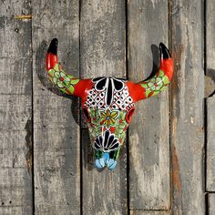 a bull's head mounted on the side of a wooden wall