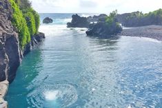 a person jumping into the water from a cliff